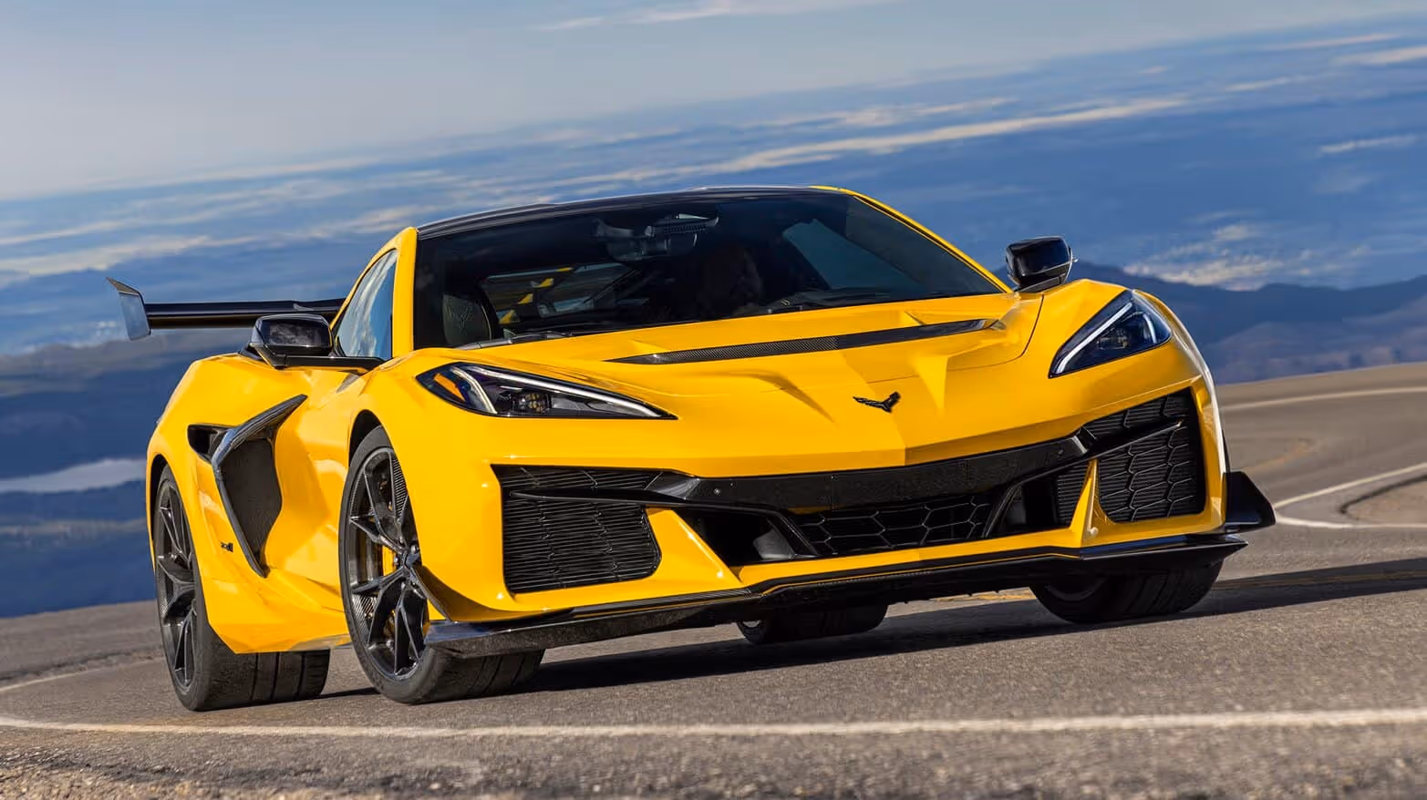 A yellow Corvette ZR1 on a mountain road above the clouds