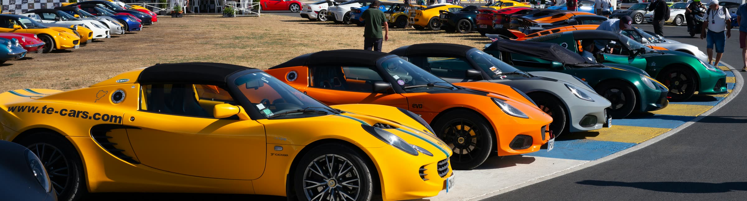 Lotus sports cars gathered at a track day