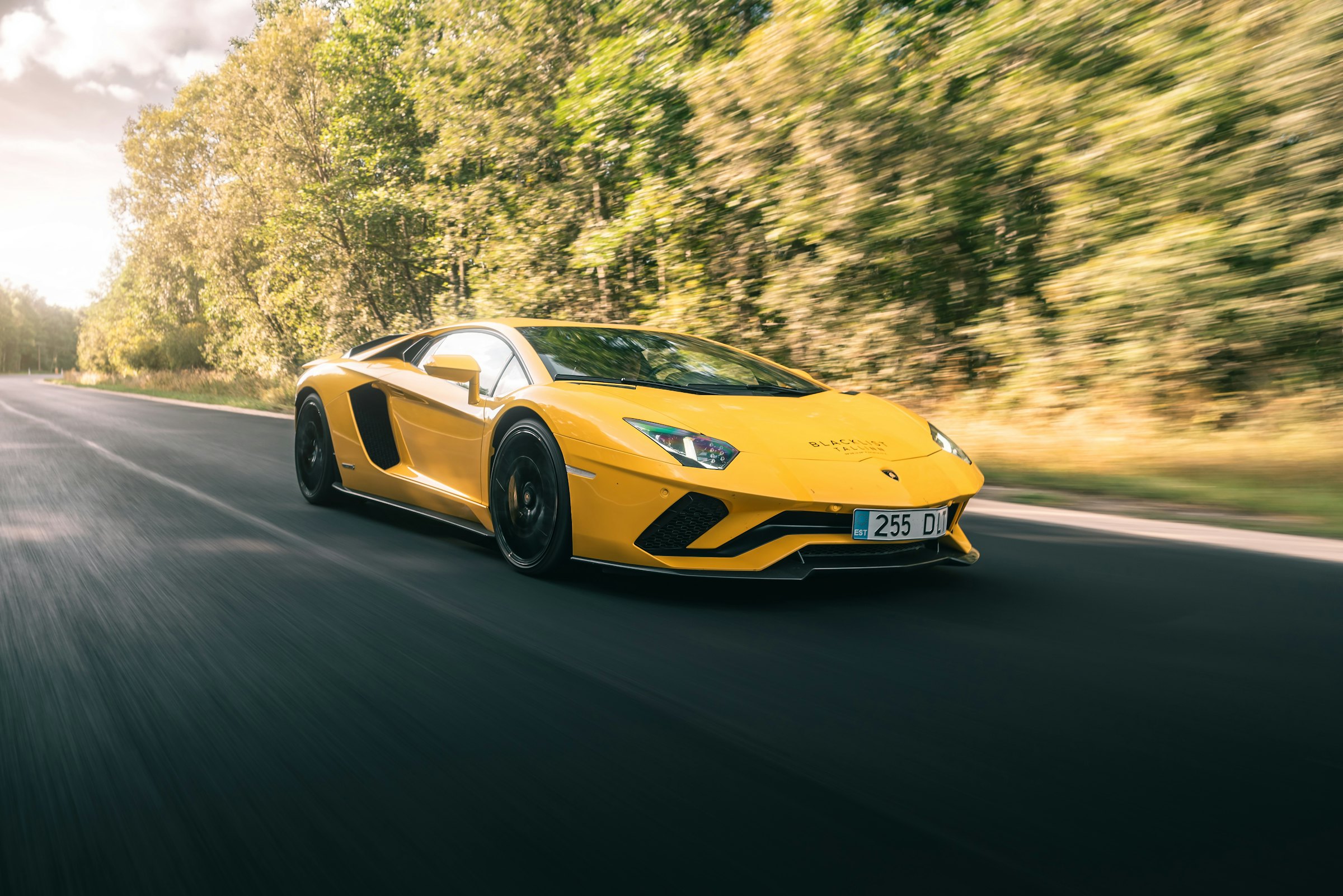 A yellow sports car on an open road